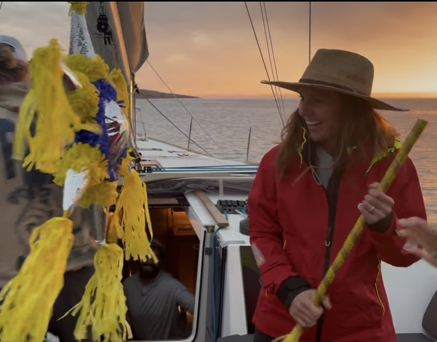Marissa Fichera laughing on a sailboat at sunset